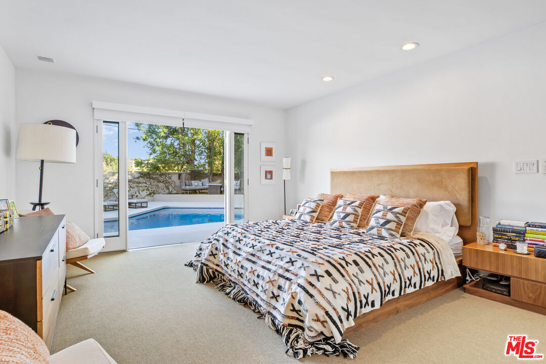 9271 Flicker Way Los Angeles, CA 90069 - Photo 17 of 28 a bedroom with a bed and a night stand
