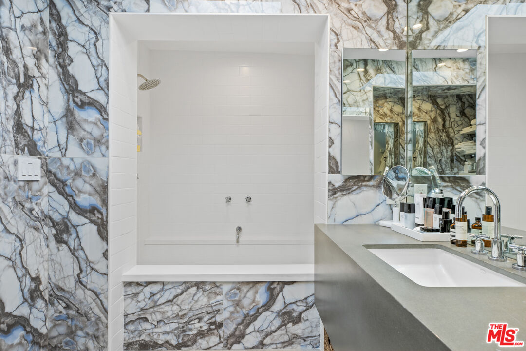9271 Flicker Way Los Angeles, CA 90069 - Photo 19 of 28 a bathroom with a sink and a mirror