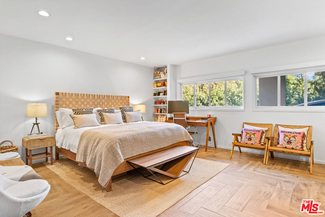 9271 Flicker Way Los Angeles, CA 90069 - Photo 21 of 28 a bedroom with a bed and wooden floor