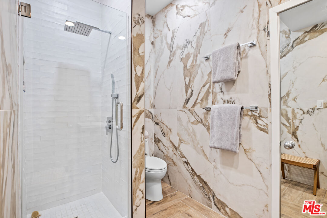 9271 Flicker Way Los Angeles, CA 90069 - Photo 23 of 28 a bathroom with a granite countertop shower and a toilet