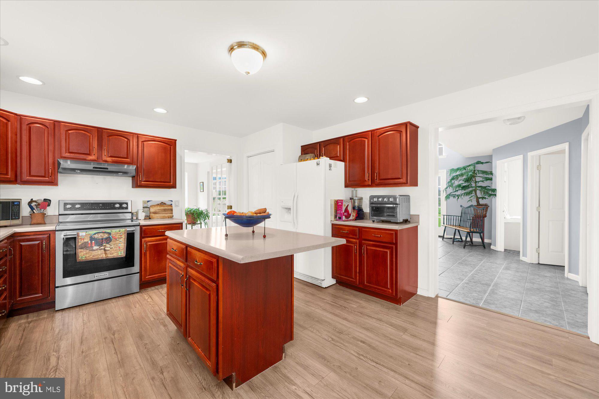 861 Dunkels Church Road Kutztown, PA 19530 - Photo 15 of 55 a kitchen with stainless steel appliances granite countertop a stove top oven a sink dishwasher and a refrigerator with wooden floor
