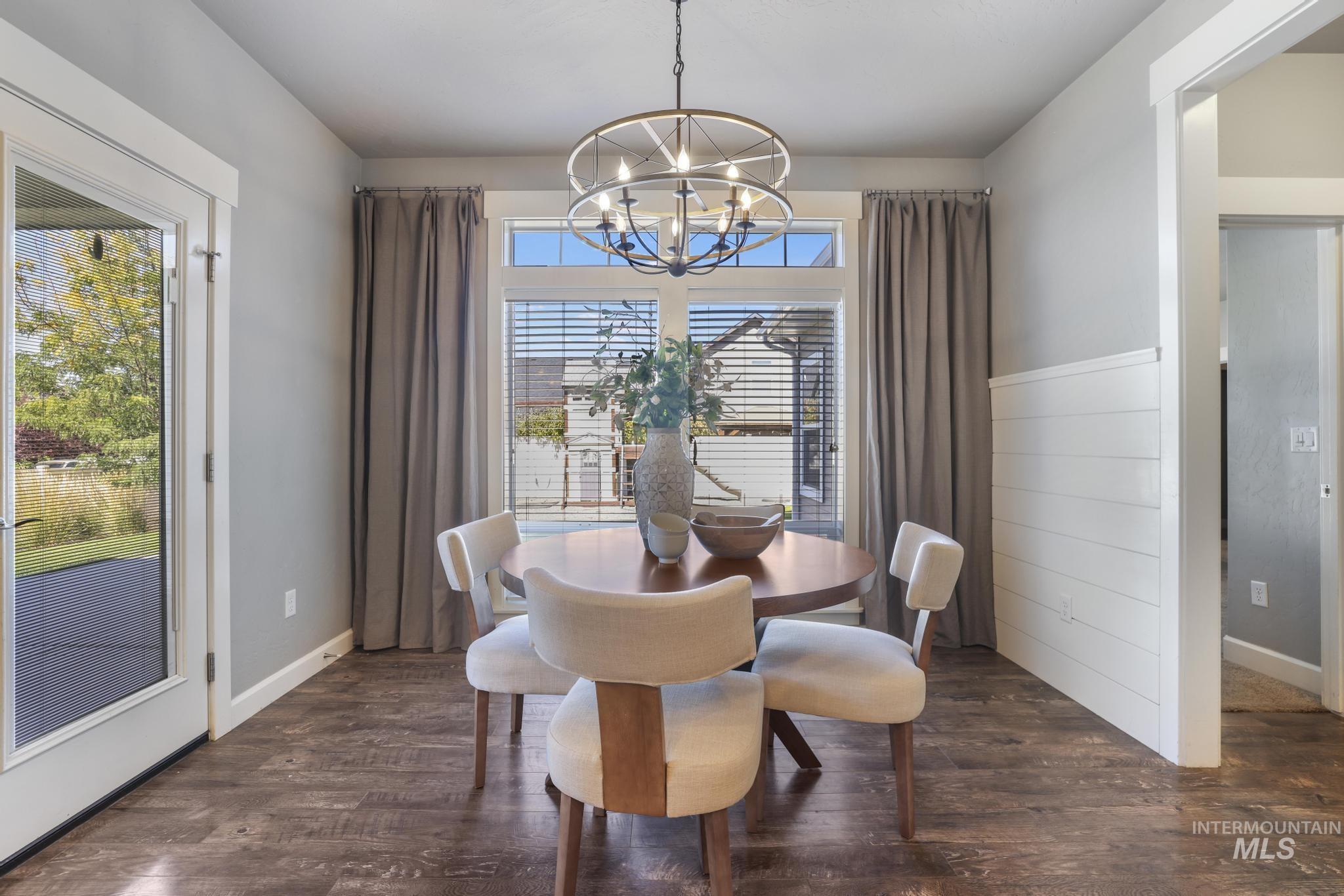2858 Sunray Loop Twin Falls, ID 83301 - Photo 14 of 45 Dining area with dark wood-style flooring and a chandelier