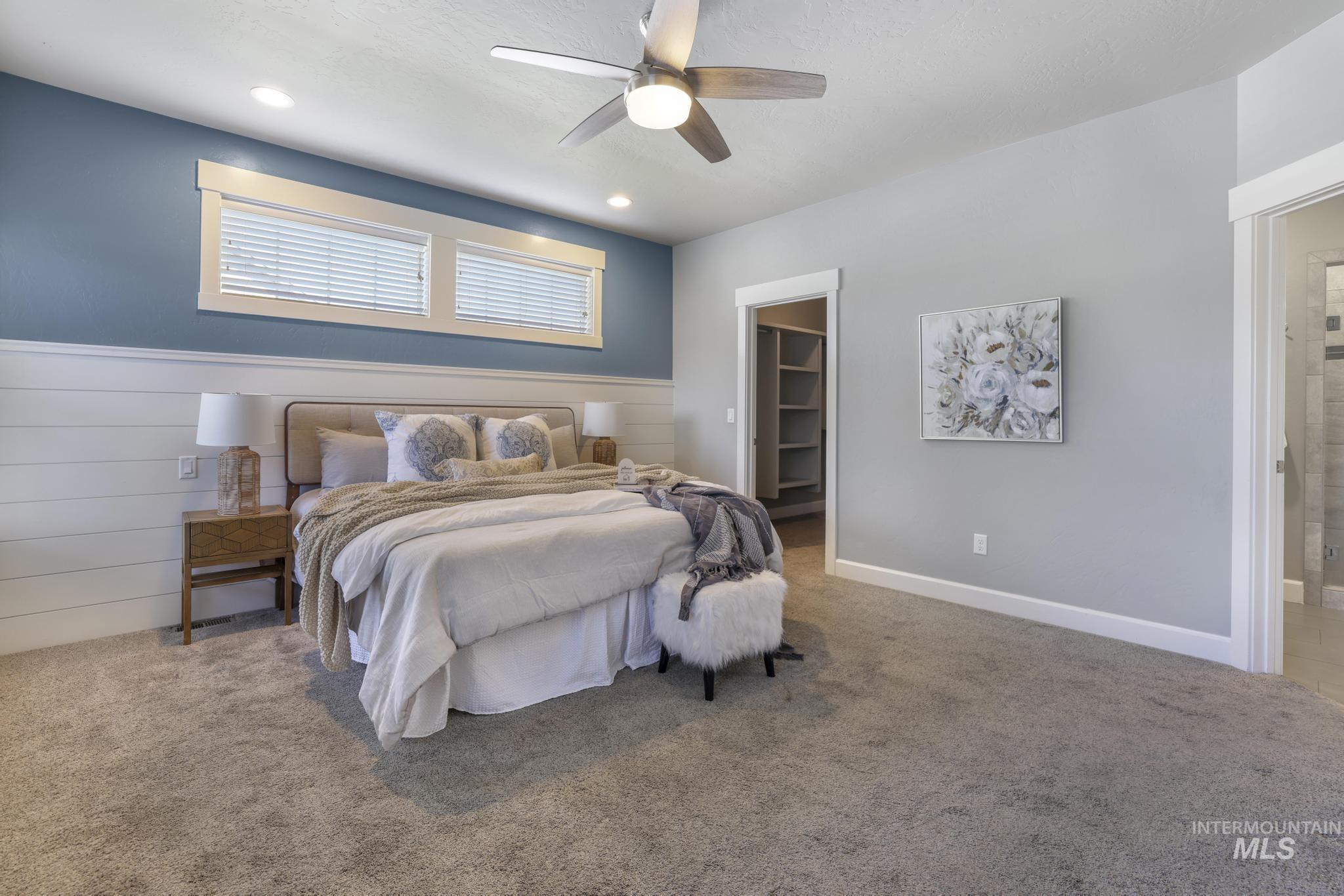 2858 Sunray Loop Twin Falls, ID 83301 - Photo 16 of 45 Bedroom featuring a spacious closet, carpet floors, ceiling fan, recessed lighting, and wood walls