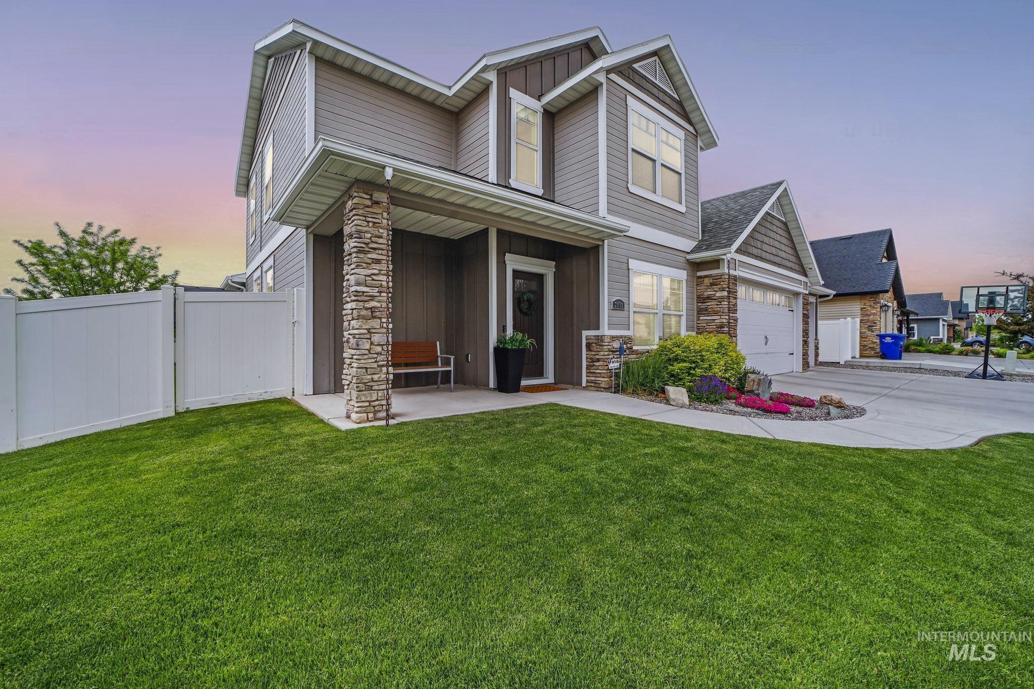 2858 Sunray Loop Twin Falls, ID 83301 - Photo 2 of 45 View of front of house with stone siding, board and batten siding, concrete driveway, and a porch