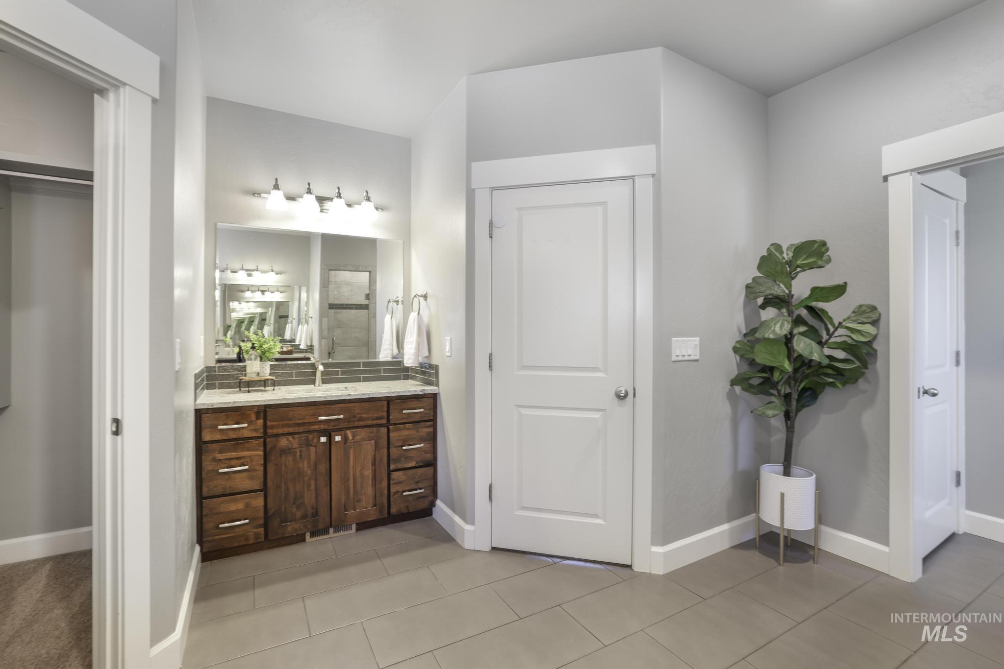 2858 Sunray Loop Twin Falls, ID 83301 - Photo 20 of 45 Bathroom featuring vanity, light tile patterned floors, and a stall shower