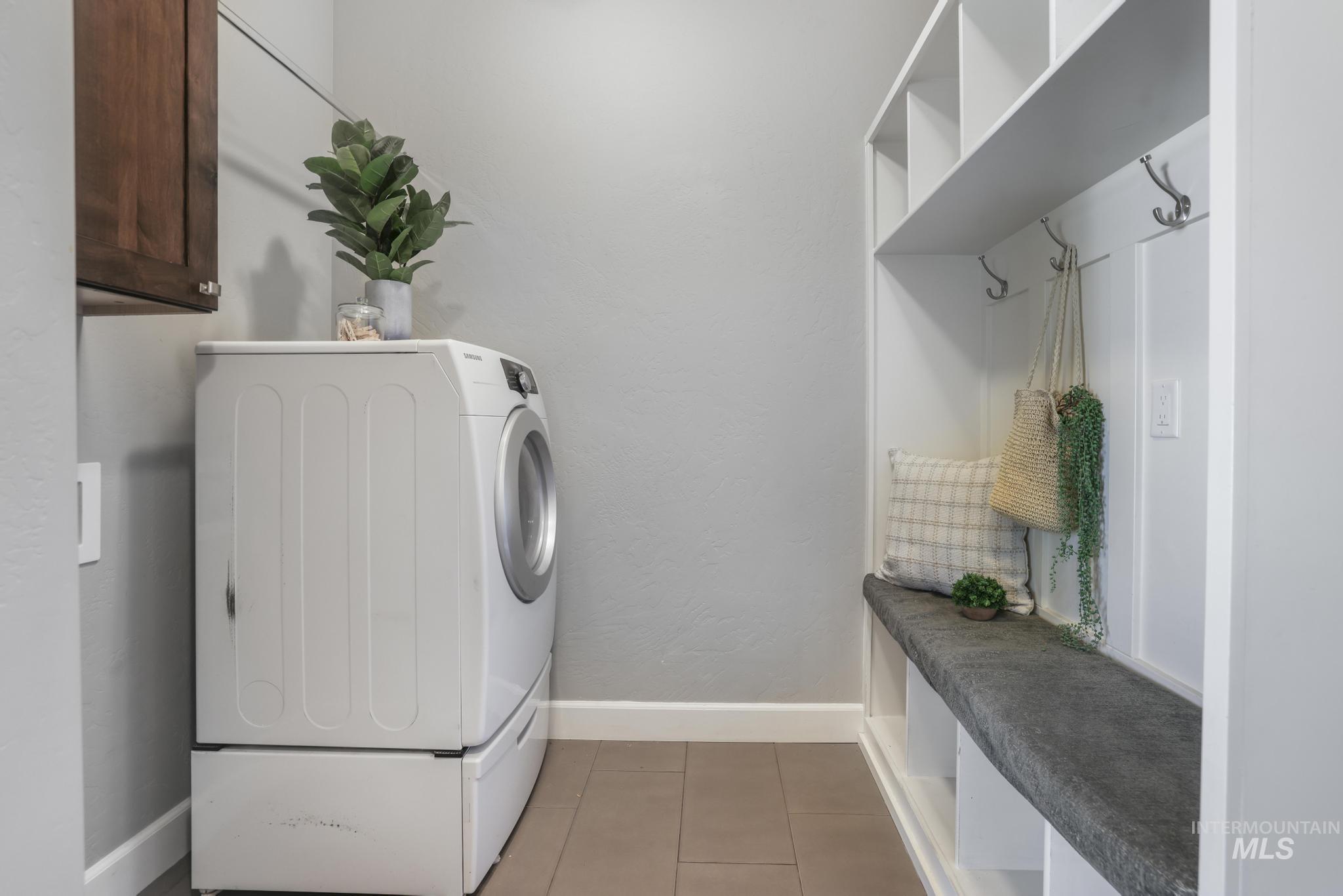 2858 Sunray Loop Twin Falls, ID 83301 - Photo 23 of 45 Washroom with washer / dryer, light tile patterned floors, cabinet space, and a textured wall