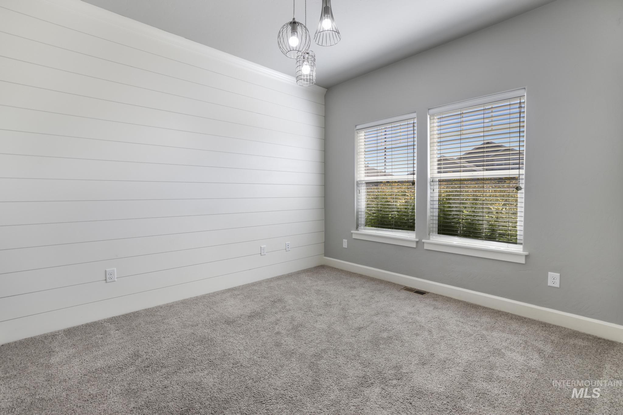 2858 Sunray Loop Twin Falls, ID 83301 - Photo 25 of 45 Carpeted empty room with baseboards and a chandelier