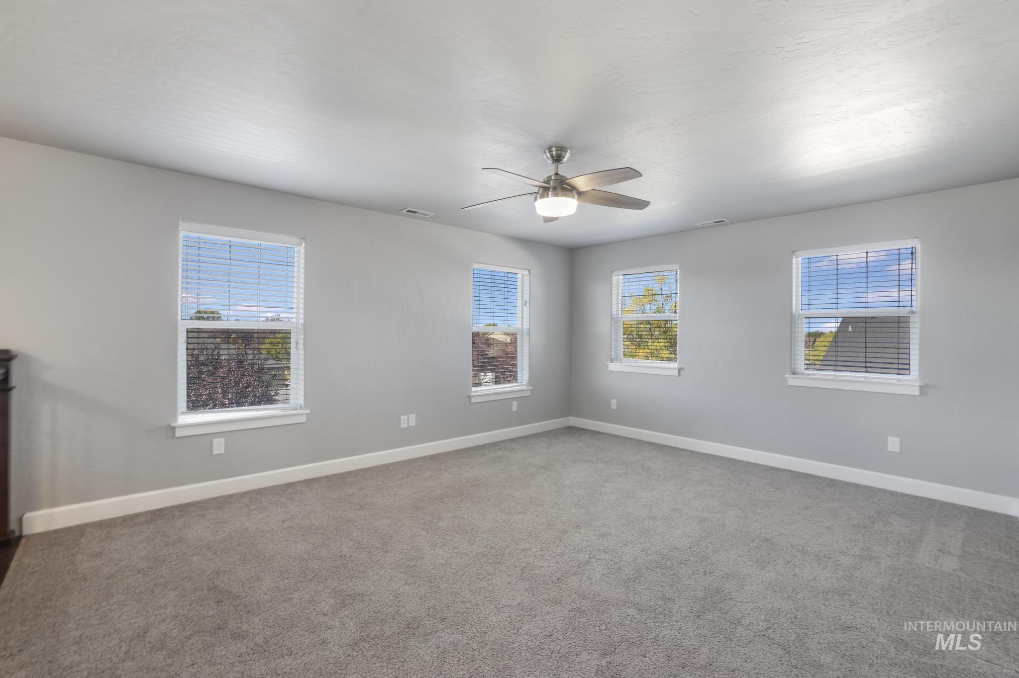 2858 Sunray Loop Twin Falls, ID 83301 - Photo 28 of 45 Spare room featuring carpet flooring, plenty of natural light, and a ceiling fan
