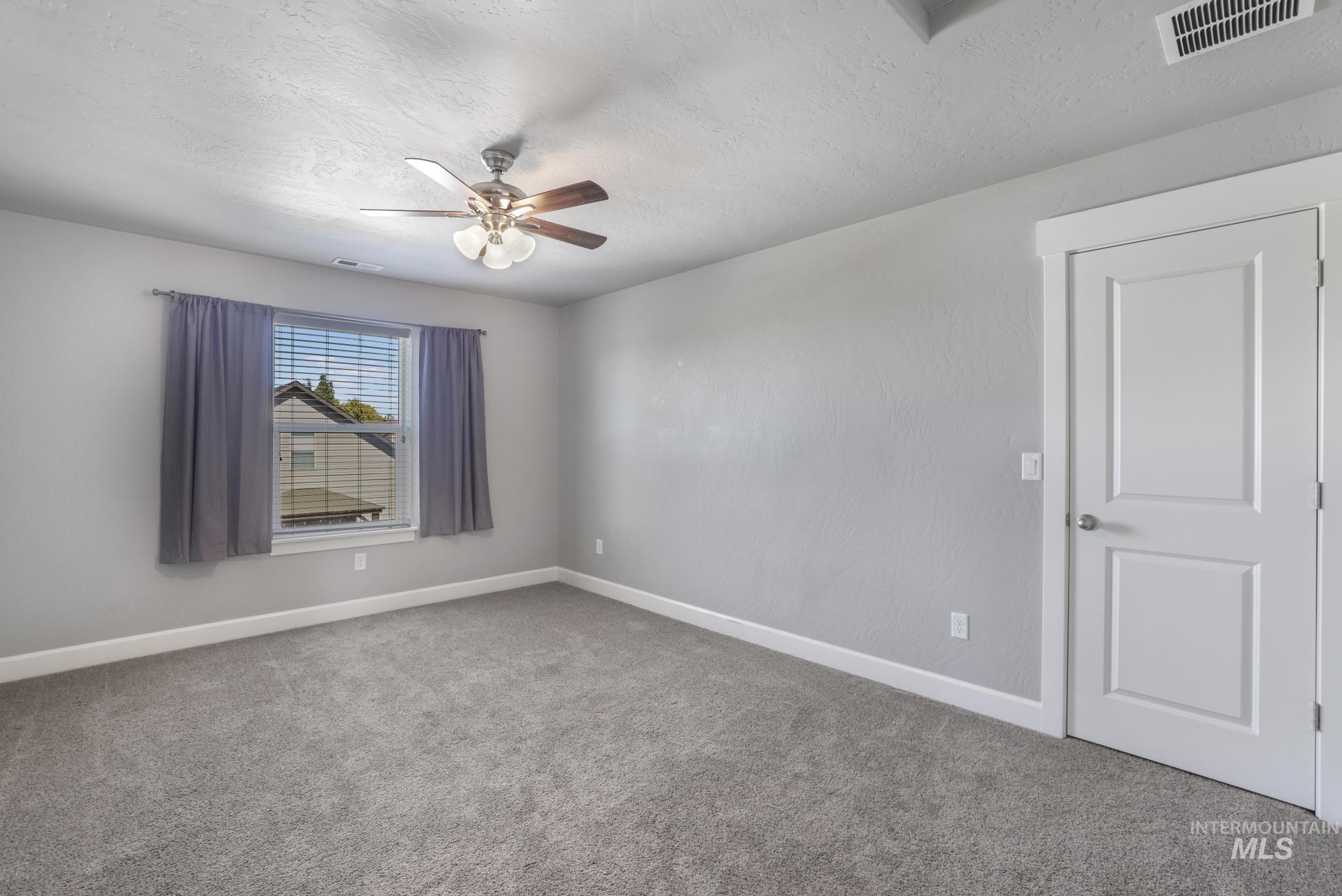 2858 Sunray Loop Twin Falls, ID 83301 - Photo 31 of 45 Carpeted empty room featuring a textured ceiling and a ceiling fan