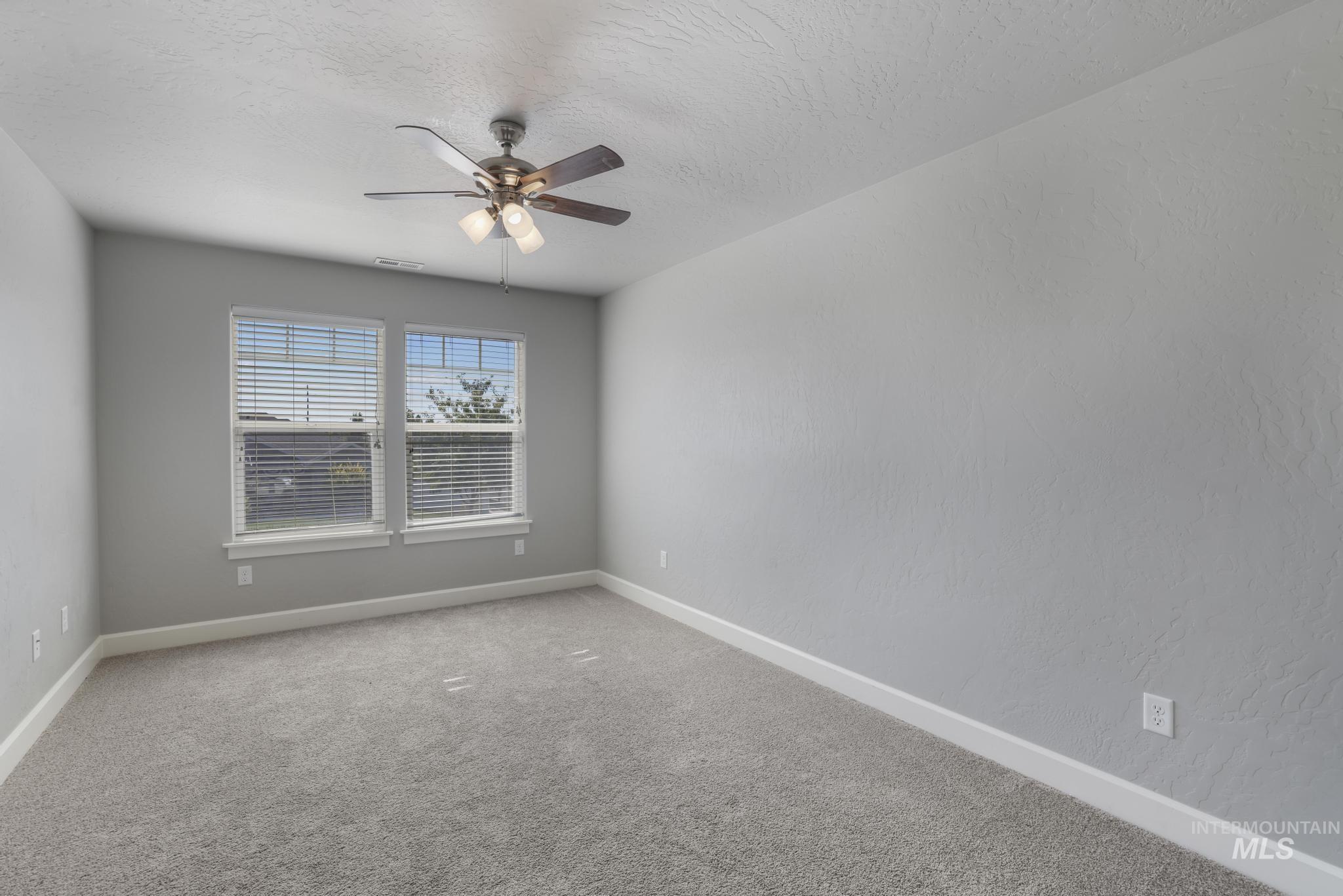 2858 Sunray Loop Twin Falls, ID 83301 - Photo 33 of 45 Carpeted spare room with ceiling fan and a textured ceiling