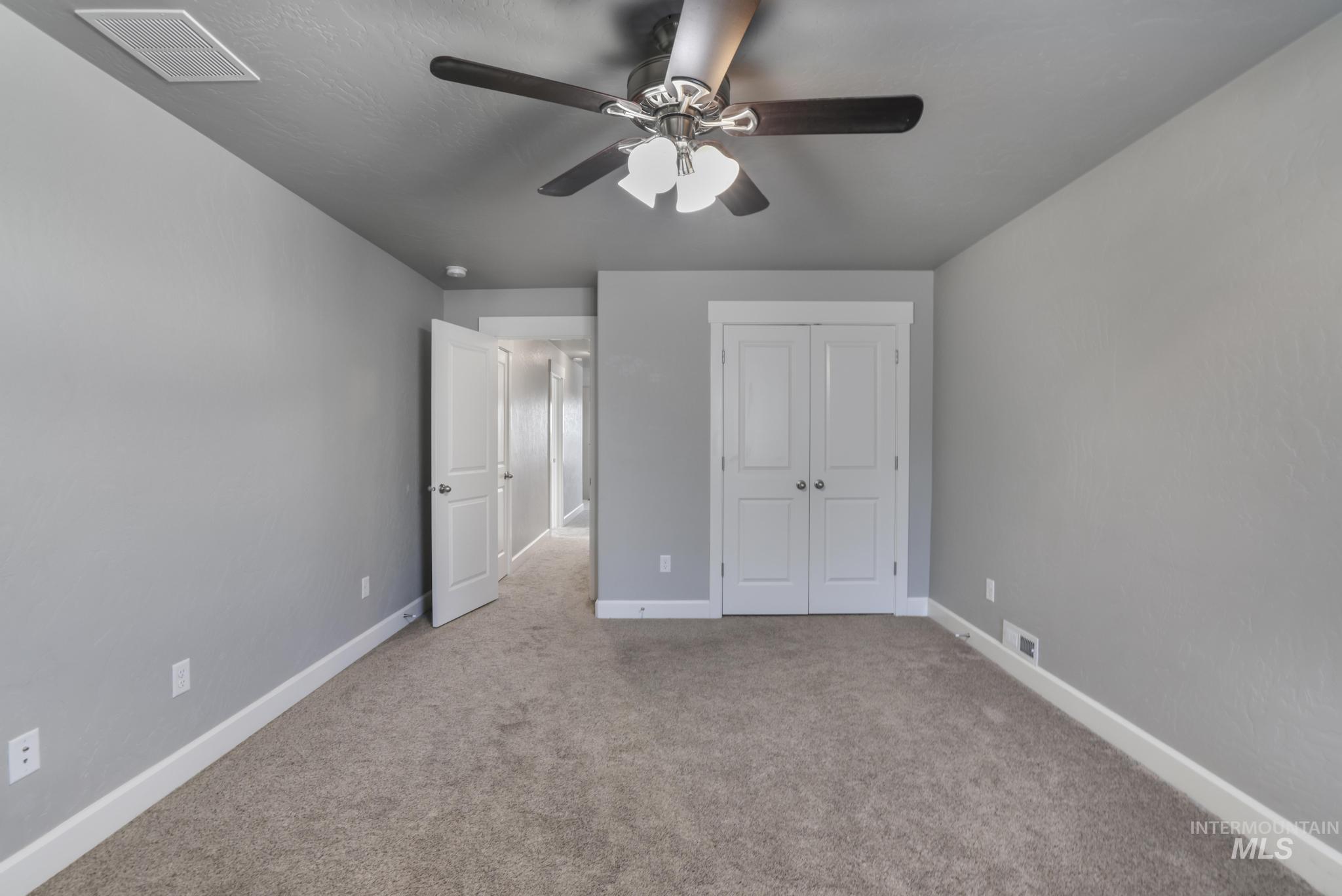 2858 Sunray Loop Twin Falls, ID 83301 - Photo 36 of 45 Unfurnished bedroom with light colored carpet, a closet, and a ceiling fan
