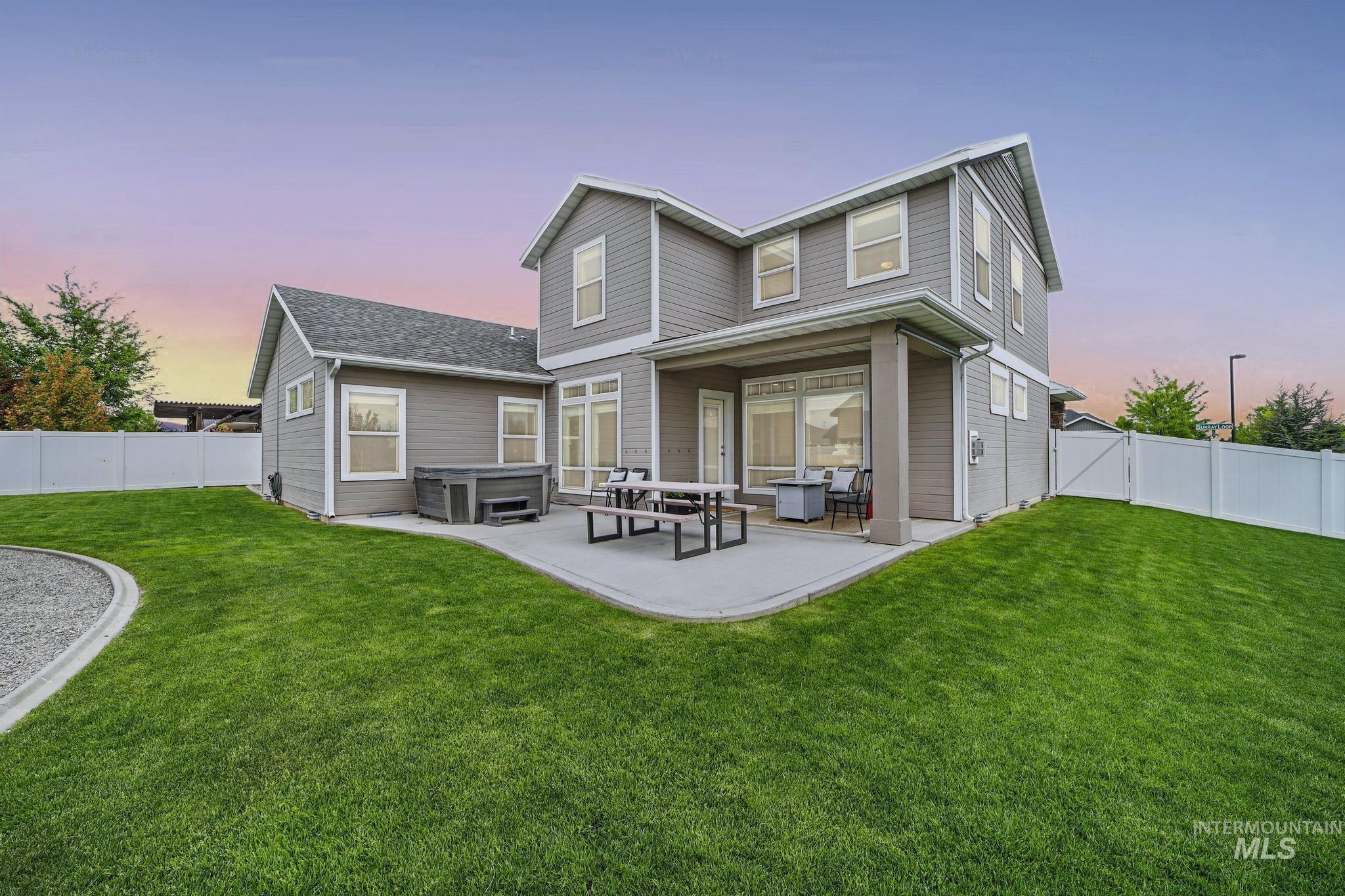 2858 Sunray Loop Twin Falls, ID 83301 - Photo 37 of 45 Back of property featuring a hot tub, a fenced backyard, and a patio