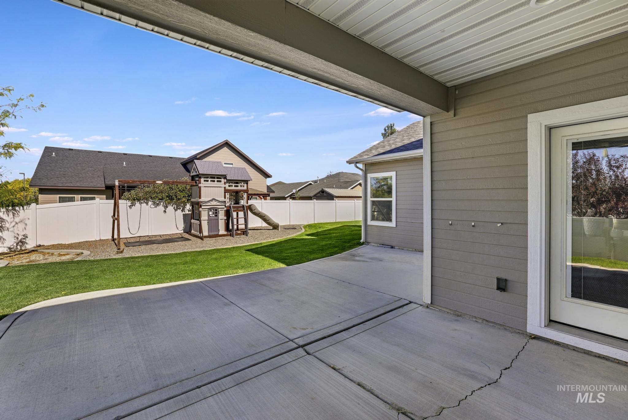 2858 Sunray Loop Twin Falls, ID 83301 - Photo 41 of 45 Fenced backyard featuring a playground and a patio area