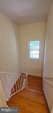 a view of wooden floor and windows in a room