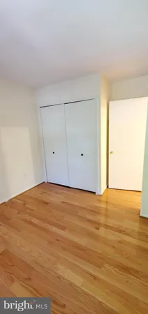 a view of an empty room and wooden floor