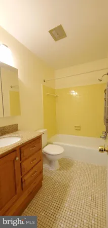 a bathroom with a sink a toilet and a bathtub