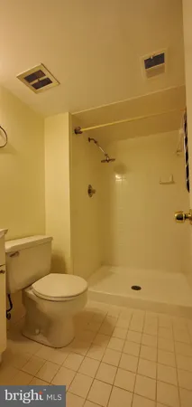 a bathroom with a toilet and a shower