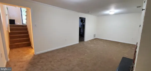 a view of hallway with stairs and a closet