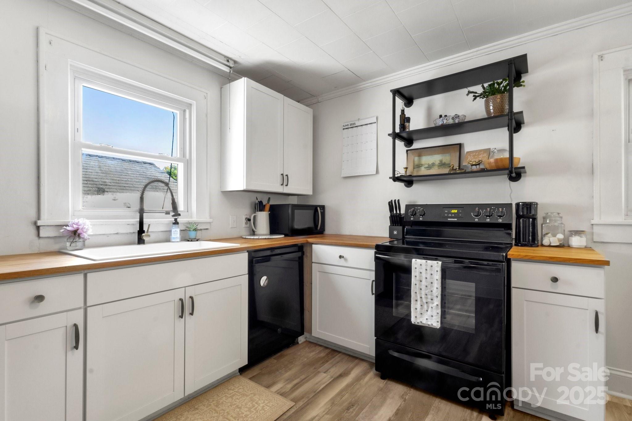 300 Cook Street Kannapolis, NC 28083 - Photo 11 of 40 a kitchen with stainless steel appliances granite countertop a stove sink and cabinets