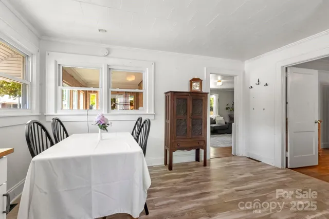 a spacious bedroom with a bed and wooden floor