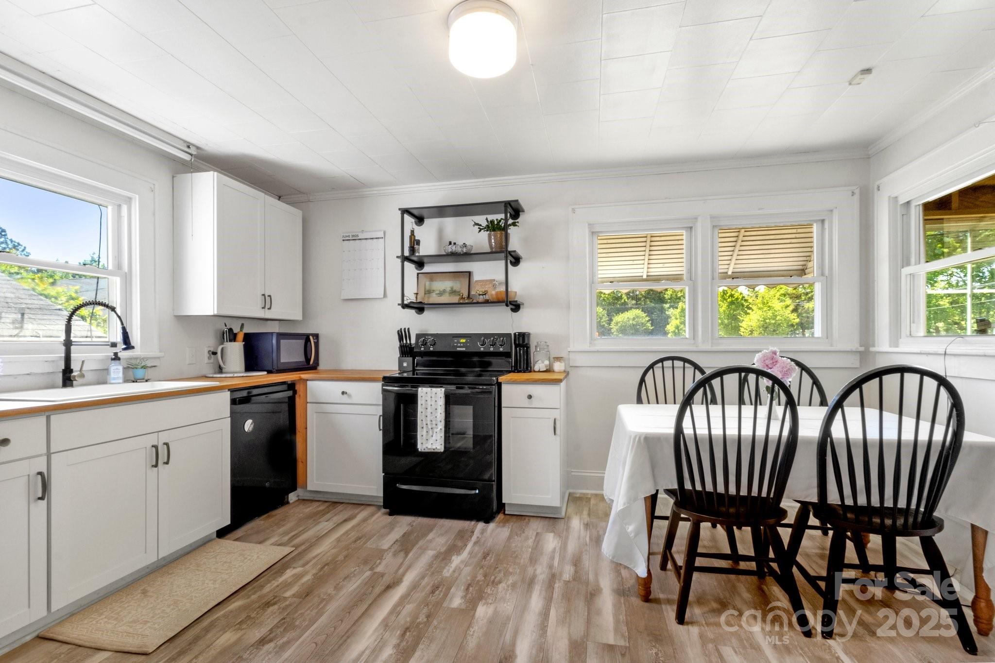 300 Cook Street Kannapolis, NC 28083 - Photo 15 of 40 a kitchen with granite countertop a stove a sink and a refrigerator