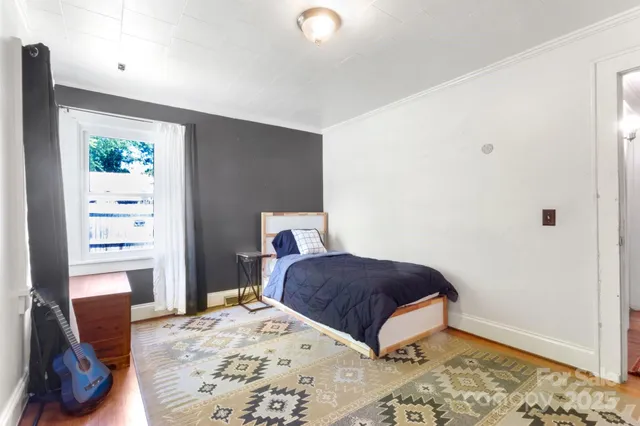 a bedroom with a bed and a window in it