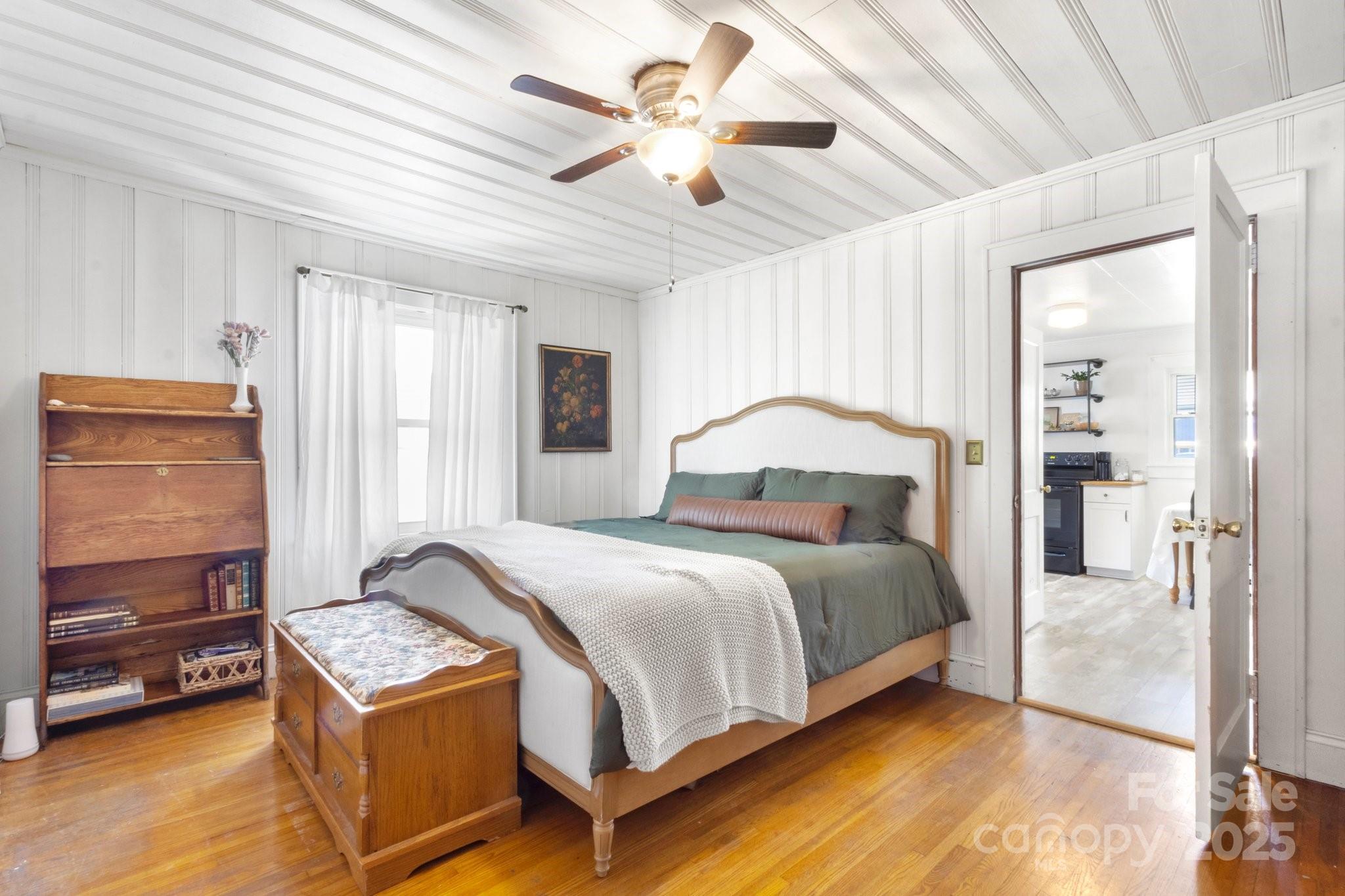 300 Cook Street Kannapolis, NC 28083 - Photo 22 of 40 a bedroom with a bed and a chandelier