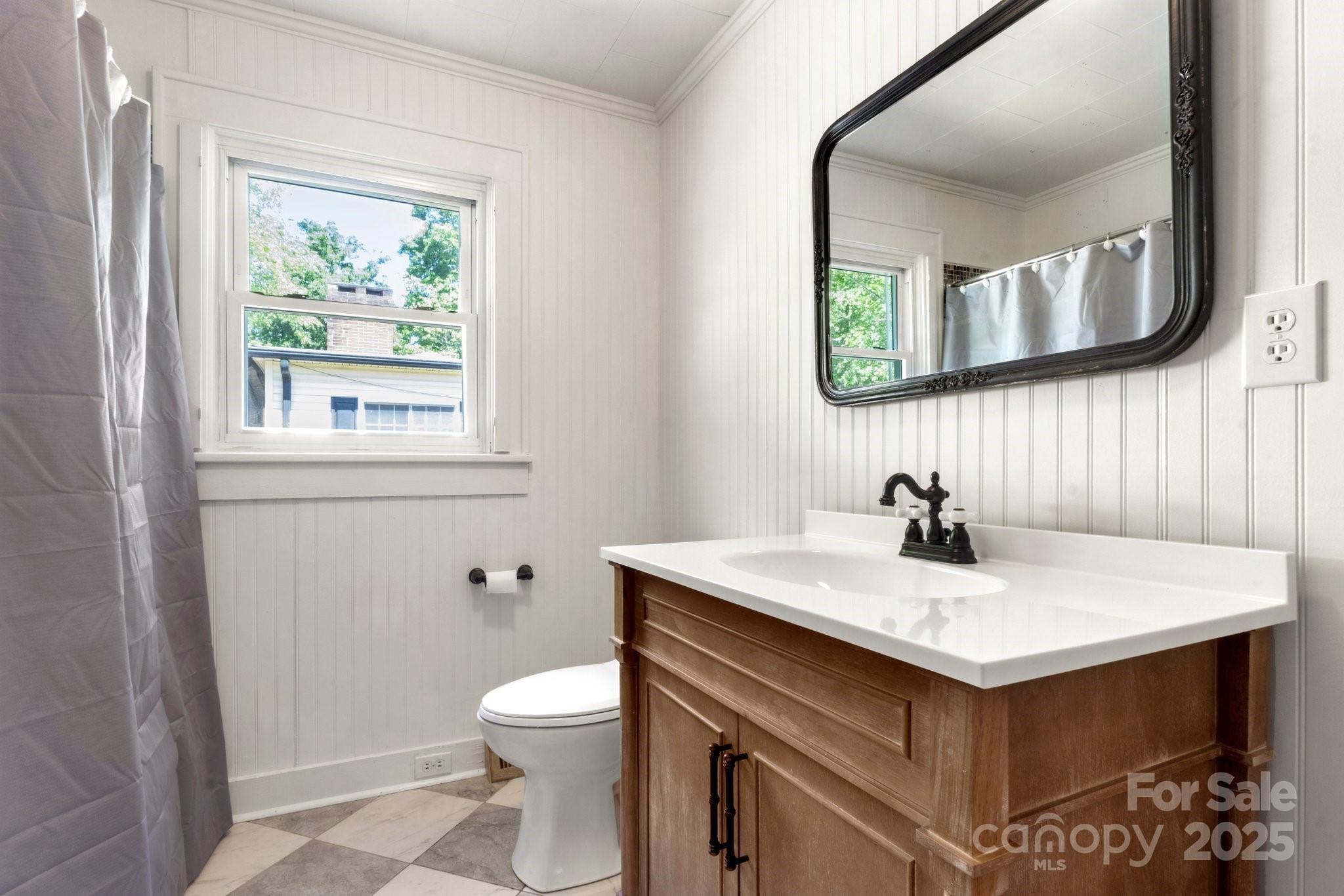 300 Cook Street Kannapolis, NC 28083 - Photo 27 of 40 a bathroom with a sink and a mirror