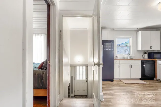 a view of a kitchen with a refrigerator and a sink