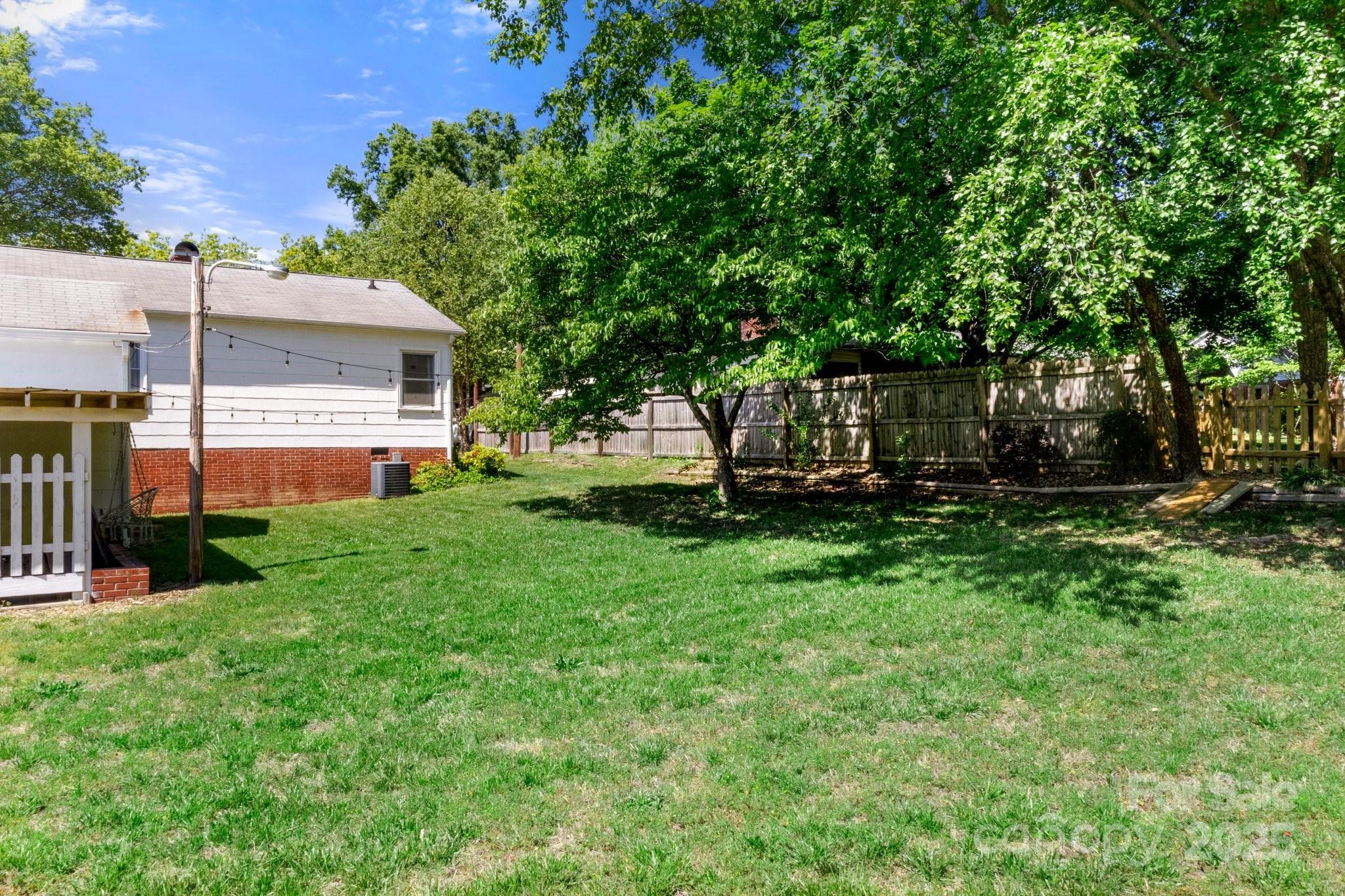 300 Cook Street Kannapolis, NC 28083 - Photo 37 of 40 a view of a backyard with plants and large trees