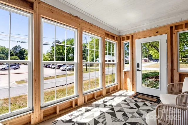 a bedroom with a bed and glass door