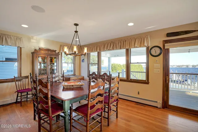 a room with pool table flat screen tv and windows