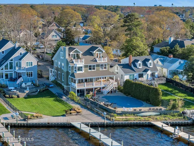 an aerial view of a house with a garden and lake view