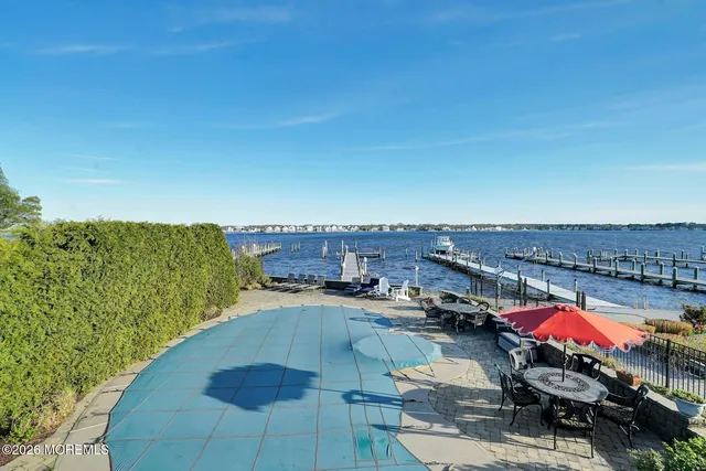 a view of swimming pool outdoor seating and city view