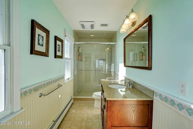 a bathroom with a sink mirror and toilet