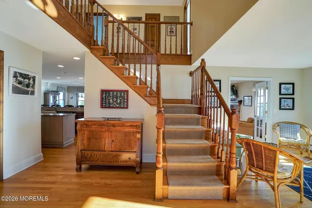 a view of entryway and hall with wooden floor