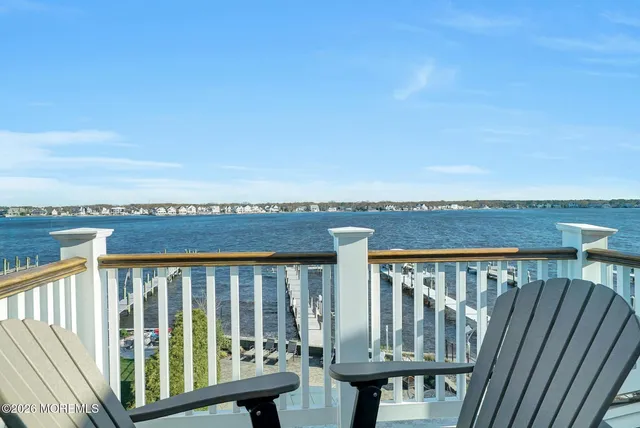 a view of a balcony with wooden floor and outdoor space