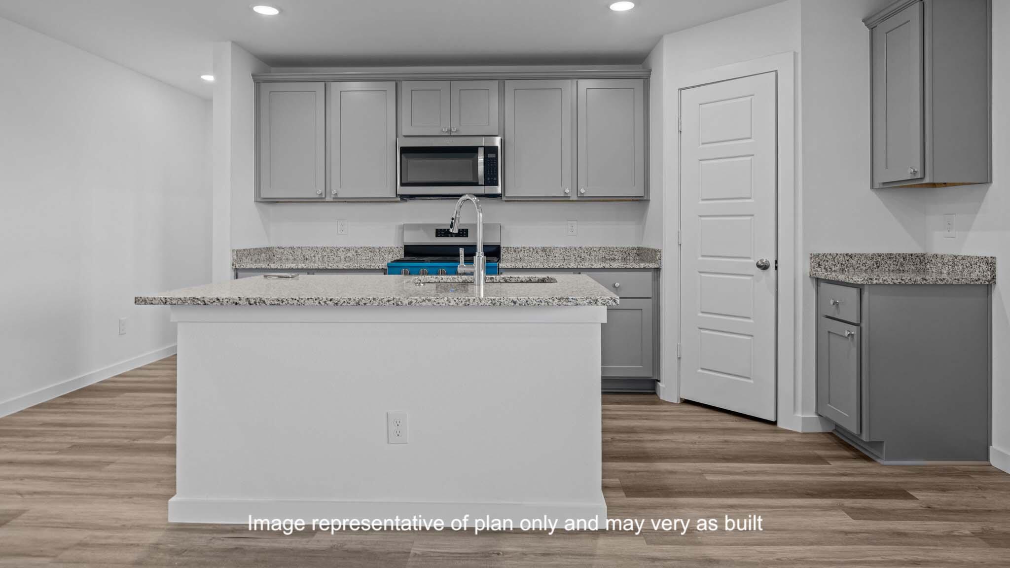 7430 9th Street Lubbock, TX 79416 - Photo 5 of 24 a kitchen with stainless steel appliances granite countertop a sink stove and microwave