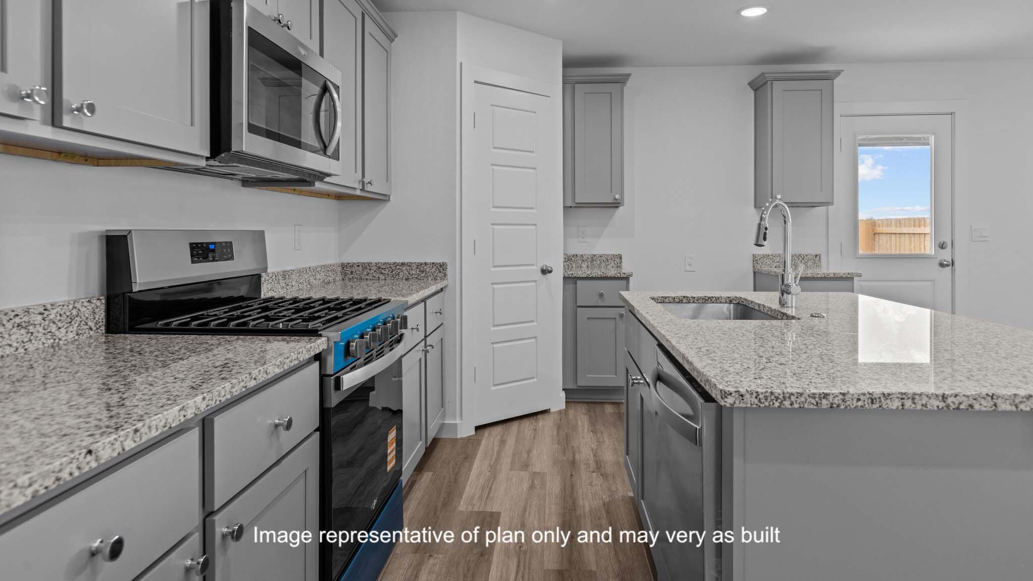 7430 9th Street Lubbock, TX 79416 - Photo 6 of 24 a kitchen with stainless steel appliances granite countertop a sink stove and cabinets
