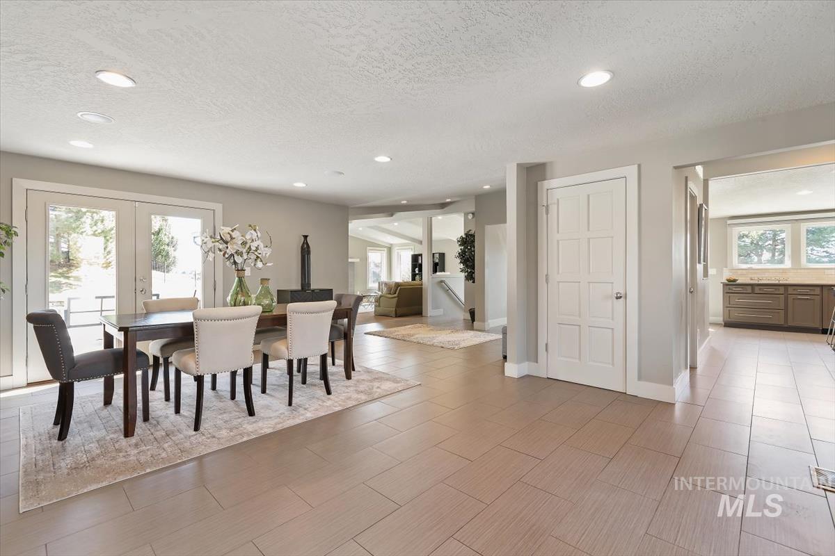 709 East Braemere Road Boise, ID 83702 - Photo 4 of 50 Recessed lighting, light gray wall paint, white trim, wood-finish flooring, and French doors