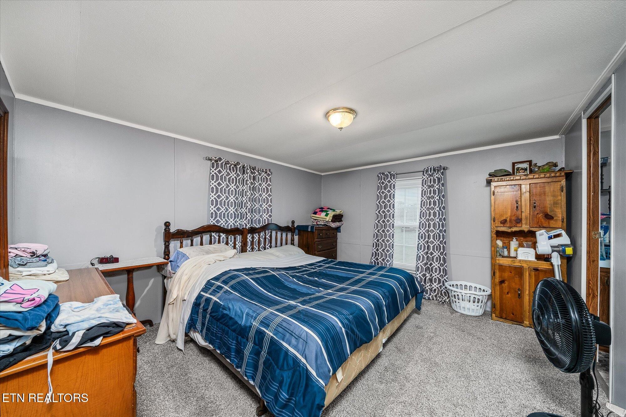 409 West Loop Road Sparta, TN 38583 - Photo 14 of 38 a bedroom with a bed and a tv