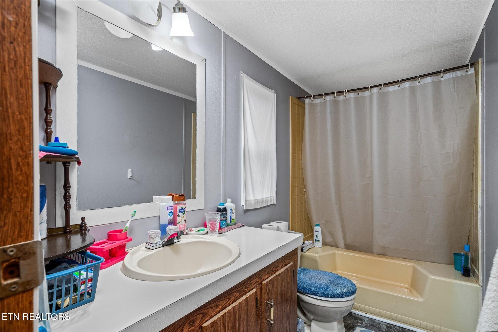 409 West Loop Road Sparta, TN 38583 - Photo 16 of 38 a bathroom with a sink toilet and shower