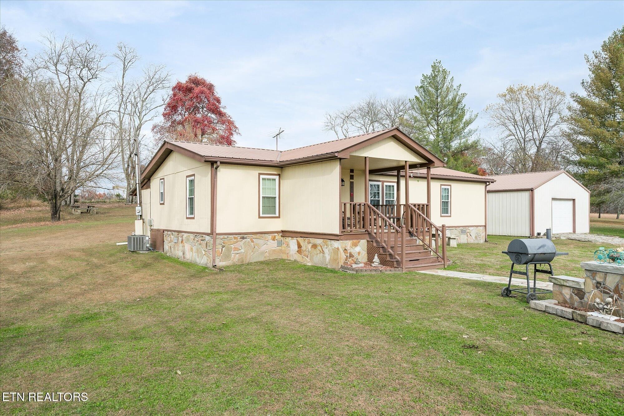 409 West Loop Road Sparta, TN 38583 - Photo 33 of 38 a view of a house with backyard and a tree