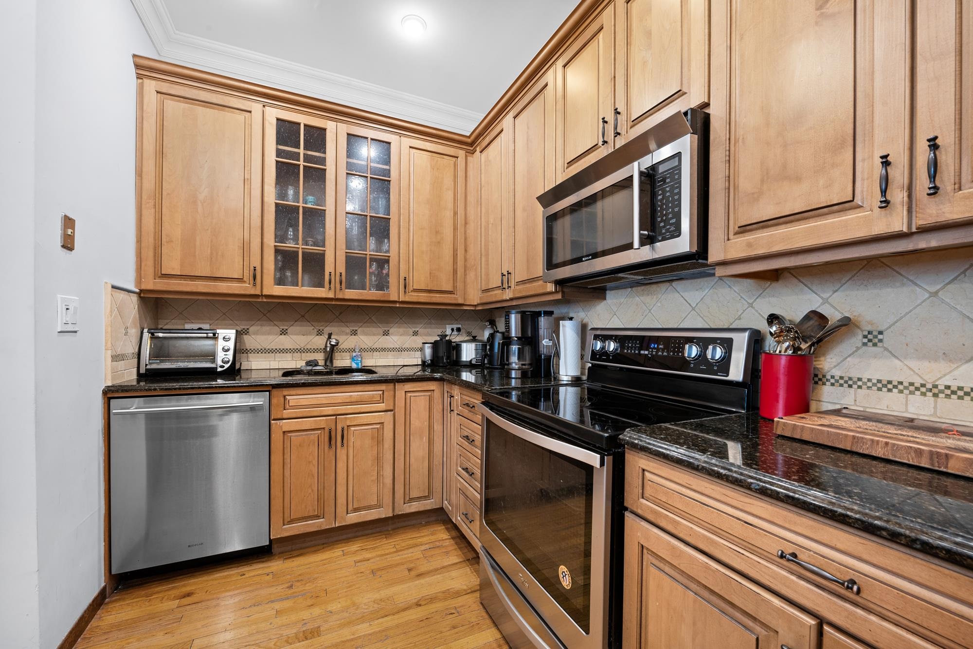 41 1st Street, Unit 1F Hoboken, NJ 07030 - Photo 4 of 8 a kitchen with stainless steel appliances granite countertop a stove and a microwave