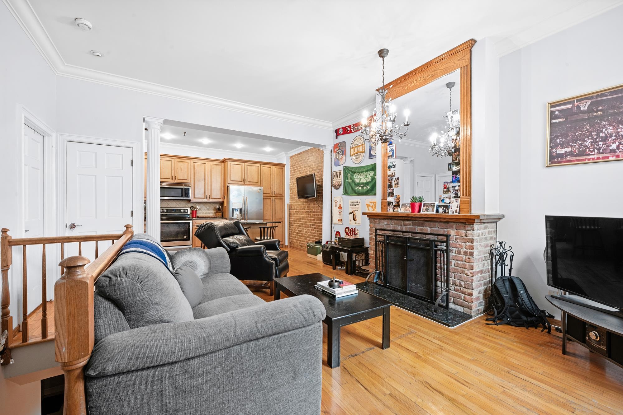 41 1st Street, Unit 1F Hoboken, NJ 07030 - Photo 5 of 8 a living room with furniture a flat screen tv and a fireplace