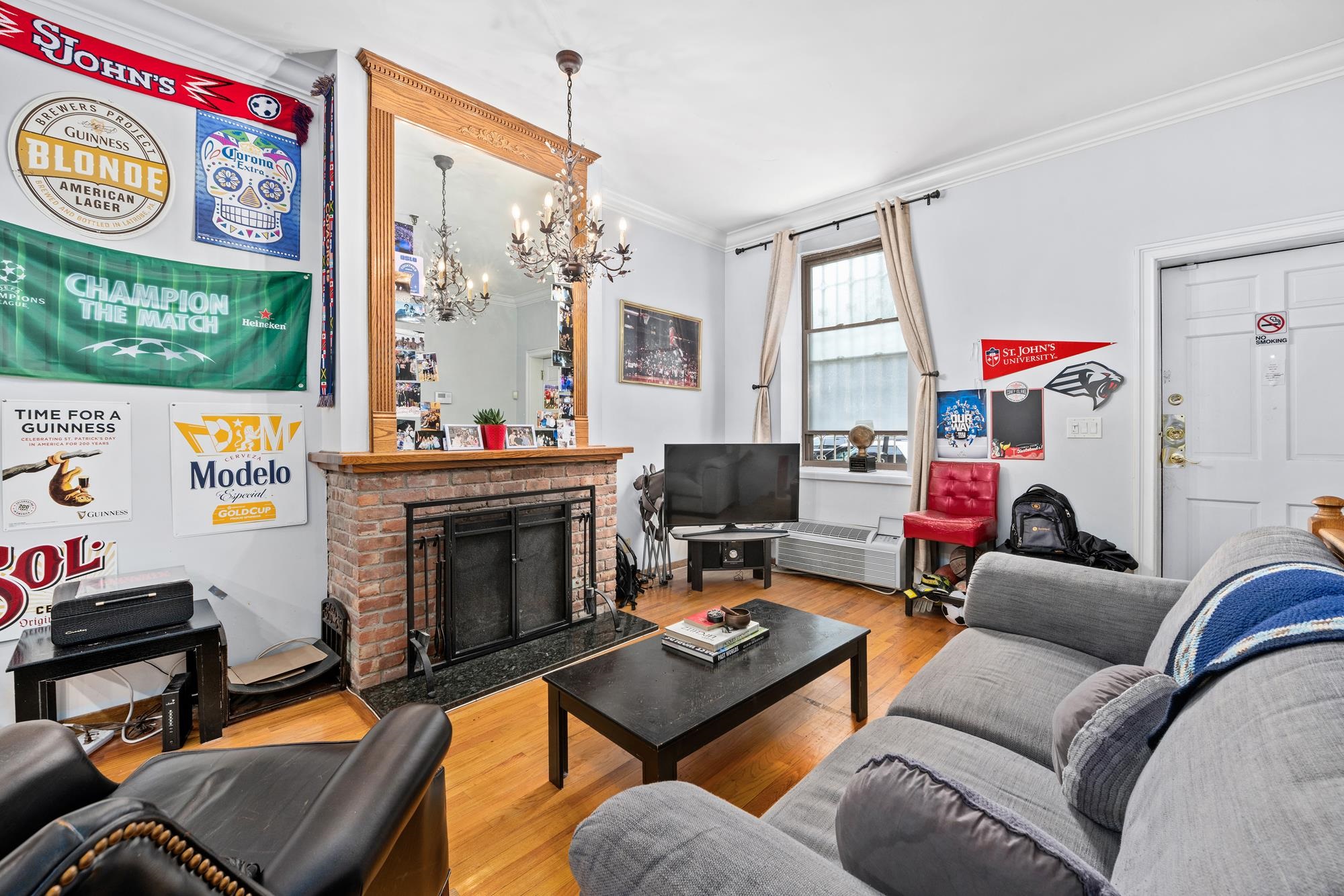41 1st Street, Unit 1F Hoboken, NJ 07030 - Photo 6 of 8 a living room with furniture a flat screen tv and a fireplace