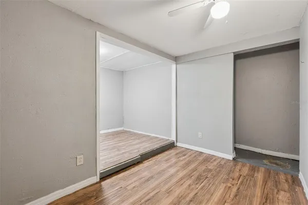 a view of an empty room with wooden floor