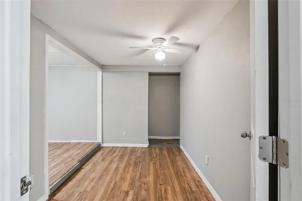 a view of a hallway with wooden floor