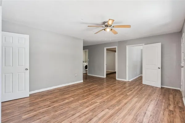 a view of an empty room with wooden floor