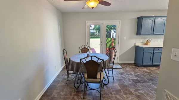 a view of a dining room with furniture and a chandelier